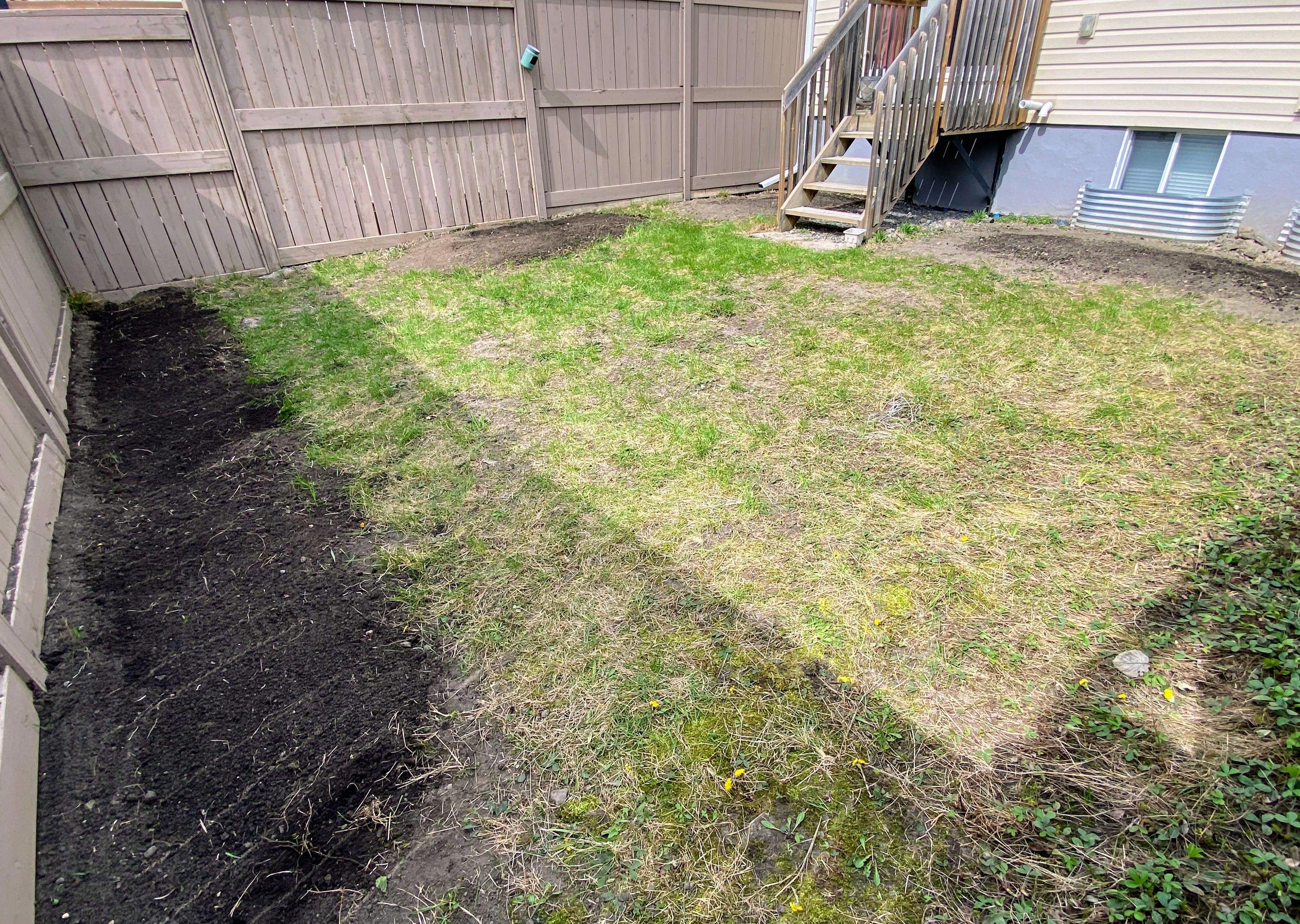 Planting areas in Bridlewood rototilled and levelled with fresh soil—ready for the garden to take root.