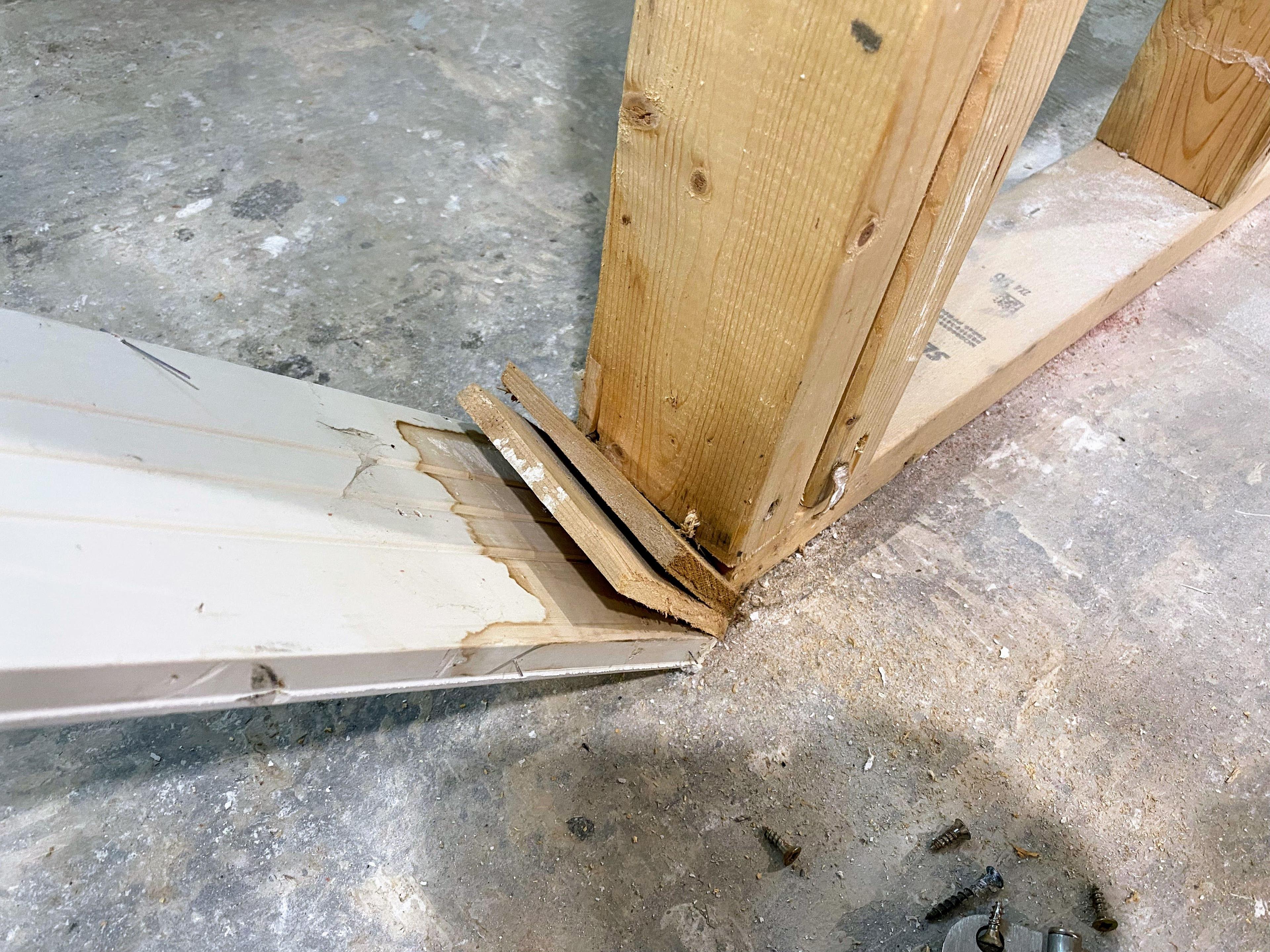 Image of a demolished door jamb showing stains left by contaminated flood water