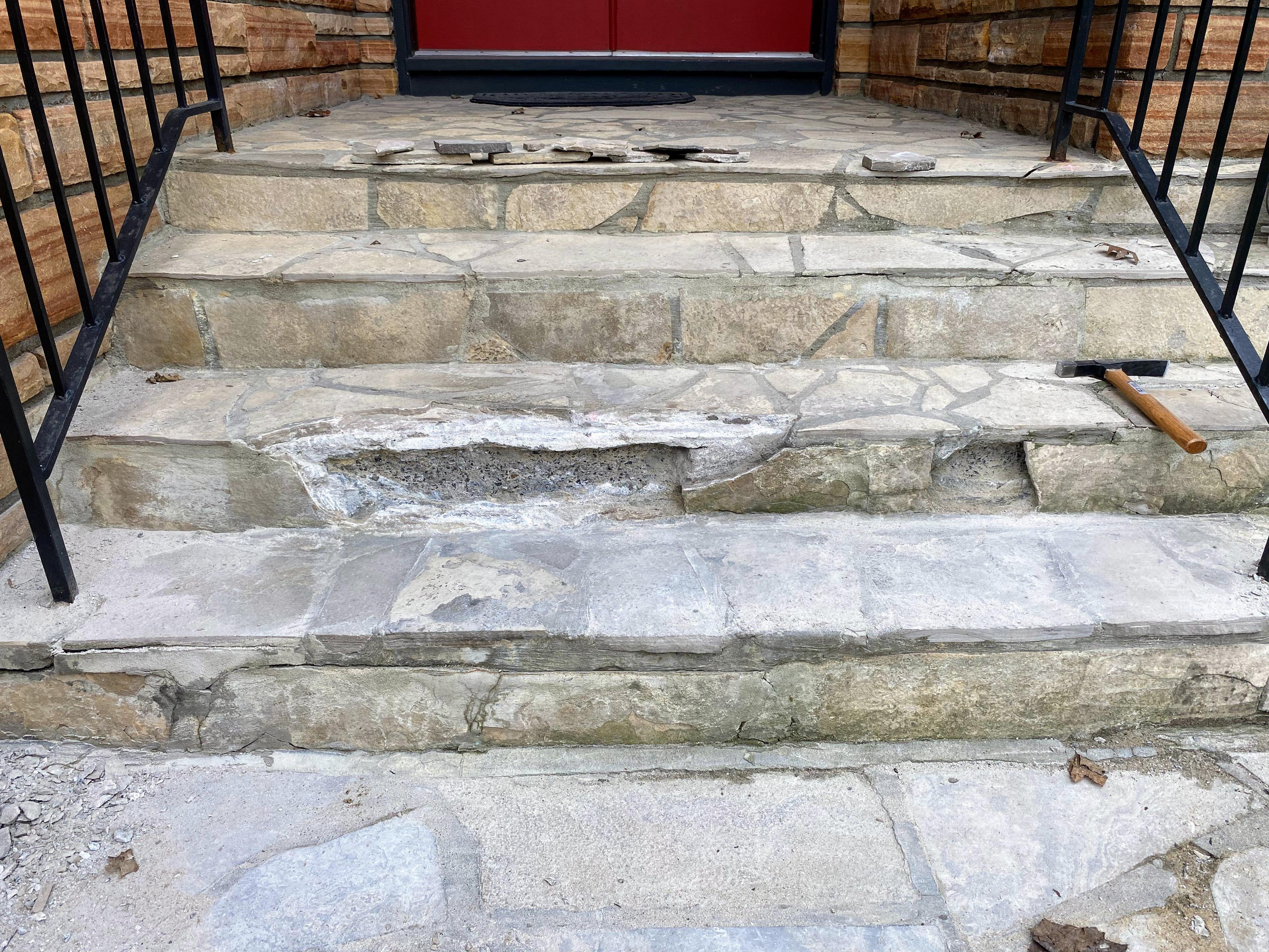 Image of a flagstone step and underlying concrete that have deteriorated over years of Ottawa freeze-thaw cycle.